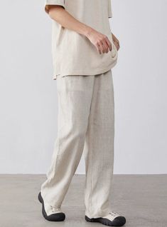 Embrace relaxed sophistication with our Linen High-Waisted Wide-Leg Trousers, perfect for any casual or smart-casual rendezvous.
Expertly tailored from a refreshing blend of linen and cotton, these trousers offer a breathable and comfortable fit, ideal for warmer days. A practical, elastic waist ensures a snug fit, while the loose straight cut and solid color design lend a touch of nonchalant elegance.
Pair them with a fitted tee or button-up shirt for a smart look, or throw on an oversized swea Casual Beige Straight Dress Pants, Casual Linen Dress Pants, Relaxed Straight Leg Bottoms In Neutral Color, Linen Bottoms With Pockets For Casual Gatherings, Neutral Linen Bottoms For Business Casual, Business Casual Linen Wide Leg Pants, Business Casual Neutral Linen Bottoms, Modern Summer Business Casual Pants, Modern Business Casual Summer Pants