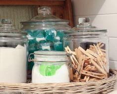 some glass jars with toothbrushes and other items in them