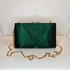 Womens dark green satin evening clutch bag with ruched detailing, gold tassel embellishment and top closing clasp Can be used with or without long shoulder chain (included) size approx- H 12cm x W 20cm Optional Dust Bag: White lightweight soft polyester portable travel dust bag pouch, suitable for protecting items from dust, dirt, hairs and scratches when not in use size approx- L 47cm x W 31.5cm Material: 100% polyester Please note, there is a cut in the top corner of the bag. In order to revea Green Elegant Evening Bag, Elegant Green Evening Bag For Events, Elegant Green Evening Bag For Event, Elegant Green Bag For Night Out, Elegant Green Clutch For Formal Occasions, Green Rectangular Evening Clutch, Chic Green Evening Bag, Elegant Green Formal Clutch, Chic Green Evening Bag For Formal Occasions