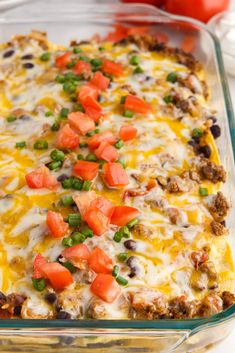 a casserole dish with meat, vegetables and cheese on top in a glass baking dish