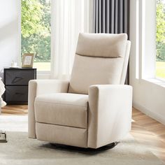 a living room with a chair, rug and window sill in front of it