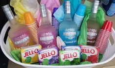 a white bucket filled with different types of juices and drinks on top of a table