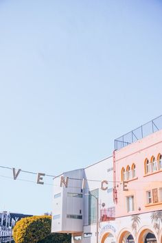 a building with a sign that says venice hanging from the side of it's roof