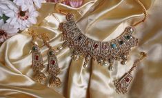 This elegant and gorgeous choker with matching earrings and tikka and is sure to be a hit for any event! The gorgeous multi and gold colors can match any outfit and the colors are gorgeous shades with a beautiful finish. Elegant Multicolor Kundan Lehenga, Elegant Multicolor Meenakari Lehenga, Festive Heavy Multicolor Lehenga, Multicolor Kundan Choker Necklace For Wedding, Bollywood Style Heavy Multicolor Sets, Multicolor Heavy Bridal Necklace For Party, Bollywood Style Multicolor Lehenga With Stone Work, Multicolor Kundan Bridal Choker Necklace, Multicolor Bollywood Choker For Party