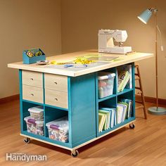 a sewing machine sitting on top of a wooden table next to a lamp and bookshelf