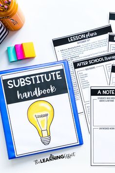 a table topped with notebooks and pens