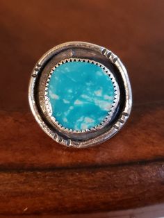 Add a touch of Southwestern style to your jewelry collection with this gorgeous handmade Sterling Silver ring. Crafted with 925 parts per 1000 Sterling Silver, this stunning 25mm round ring features a beautiful simulated turquoise enamel stone. The ring is a statement piece that is sure to make a bold impression. NOTE: It's possible that this is real Turquoise, but I really cannot tell so I'm listing it as Enamel. This pre-owned vintage piece is non-specific to gender and is sizeable. The ring shape is round - the simulated turquoise measures 18mm round in a bezel setting style (the outside measurement with the Silver is 25mm). The solid Sterling Silver ring weighs 14.4 grams and is perfect for anyone who loves unique and handmade jewelry. Whether you're dressing up or going casual, this r Handmade Sterling Silver Rings, Real Turquoise, Ring Shapes, Enamel Ring, Round Rings, Southwestern Style, Handmade Sterling Silver, Silver Turquoise, Turquoise Sterling Silver