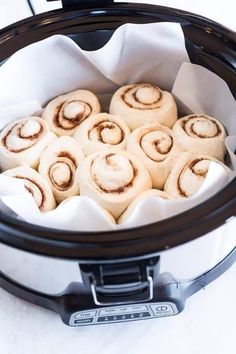 several rolls in a slow cooker on a table