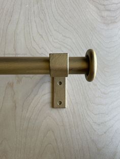 a close up of a metal handle on a wooden door