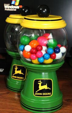 two gummy machines sitting on top of a wooden table