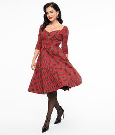 Don’t stay bored, darling! A fabulous frock for a maven on the prowl, the Lamar Dress is a dramatic piece from Unique Vintage, cast in a beautiful red plaid bengaline to showcase your heart-stopping silhouette. With fabulous 1950s style design, the stunning sweetheart neckline features an adorable faux button. The pointed and wide waistband and classy three-quarter length sleeves provide stunning form as the knife pleated swing skirt cascades past your knees to a straight hem. Outfitted with a back zipper to nip in your figure, make it happen!.Crinoline added for volume, sold separately..Available in sizes XS-5X while supplies last. | Unique Vintage 1950S Red Plaid Lamar Swing Dress | Size Xsmall/2 Knife Pleat, 1950s Style, 1950s Fashion, Knee Length Skirt, Wide Waistband, Large Size Dresses, Nordstrom Dresses, Red Plaid, Swing Dress