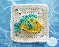 a crocheted cell phone case with a yellow fish on it