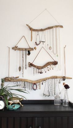 there is a wall hanging with jewelry on it