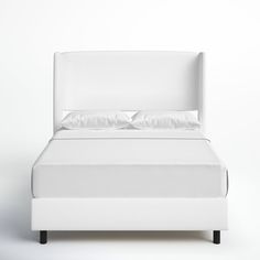 a bed with white sheets and pillows on it's headboard, against a white background