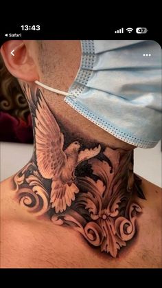 a man with a neck tattoo has an eagle on his chest and is wearing a surgical mask