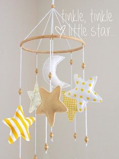 a mobile with stars, moon and crescent hanging from it's sides that says twinkle twinkle little star