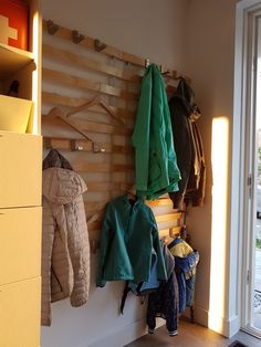 a coat rack with coats hanging on it