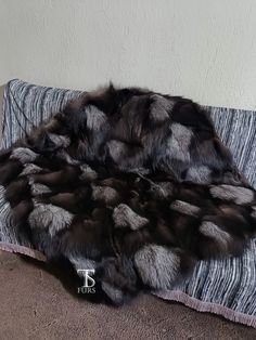 an animal fur rug sitting on top of a carpeted floor next to a wall