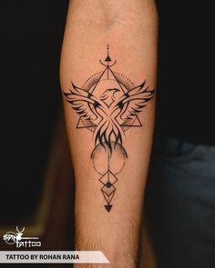 a tattoo on the leg of a man with an eagle and geometric design in black ink