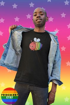 a man wearing a black shirt with a rainbow bee on it