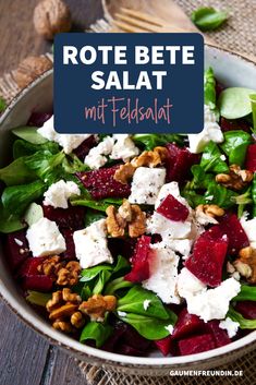 a salad with beets, feta cheese and walnuts in a white bowl