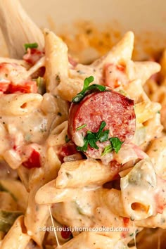 a close up of a pasta dish with sausage