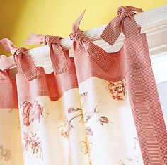 red and white checkered curtains hanging on a window sill