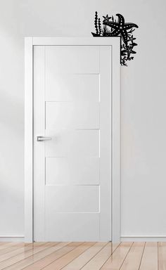 an open door in a white room with a black silhouette of a bird on it