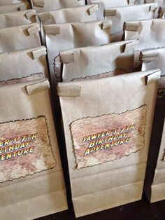 several brown paper bags with writing on them