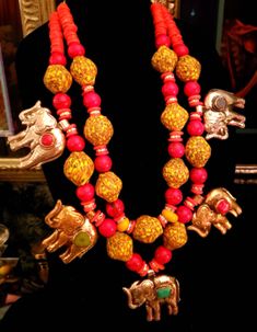 I am very pleased to present this massive, and very heavy red and yellow African beaded Statement Necklace - Tibetan Repousse Elephant Chest Piece. Five ornate silver and gold tone handcrafted elephants are inlaid with turquoise, jade, coral and lapis. They are as ornate on the back as they are on the front. Huge yellow and red African glass beads anchor this piece of badass jewelry while round red magnesites, orange coral disks, gold aurora borealis rhinestone rondelles and yellow resins add fu Red Necklaces With Motifs For Festivals, Rocker Chic Accessories, Unique Pendant Necklace, Statement Bib Necklace, Chest Piece, Orange Coral, Mermaid Necklace, Beaded Statement Necklace, African Beads