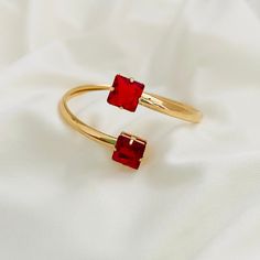 Are you looking for the perfect complement to your jewelry collection? Our Red Cuff Bracelet has the July stone, the Ruby, special to make a unique gift for the birthday girls of that month and for people who love this color. Our Ruby Bangle Bracelet is just what you need. Its beautiful red stones will make you shine and dazzle in front of everyone, ideal for any occasion. If you like it, click on the cart, and we will prepare it for you!  Product: - Ruby Bracelet -Material: 18K Gold Filled -Ban Red Gemstone Bracelets As Gift, Red Gemstone Bracelets For Gift, Red Metal Crystal Bracelet Gift, Adjustable Ruby Bracelets Gift, Ruby Bracelets With Jubilee Bracelet As Gift, Ruby Bracelets With Jubilee Style As A Gift, Red Ruby Bangle As Gift, Ruby Jubilee Bracelet As A Gift, Ruby Jubilee Bracelet Gift