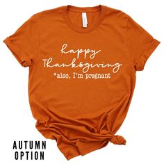 an orange shirt that says happy thanksgiving also i'm pregnant