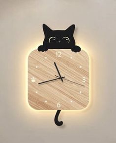 a wooden clock with a black cat on it