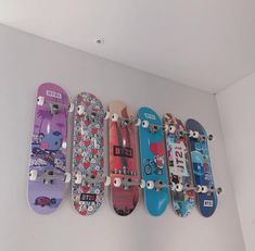 a row of skateboards mounted to the wall