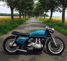 a blue motorcycle parked on the side of a road