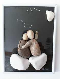 two rocks are sitting on top of each other in the shape of a couple hugging