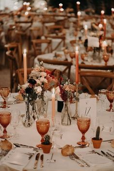 the table is set with candles and flowers