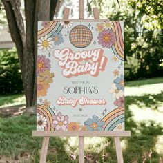 a sign that says grooy baby on it in front of some grass and trees