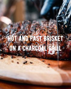 a bbq with the words hot and fast brisket on a charcoal grill