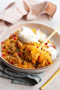 a white bowl filled with food on top of a table