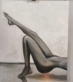 a painting of a naked woman laying on the floor in front of a white wall