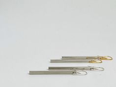 "Simple, stylish, yet sophisticated, this pair of earrings feature sleek silver long bars, suspended from minimalist modern hooks. The earring hooks are made of 925 sterling silver, with or without gold plating. The bars are made of brass with silver plating. The earrings is about 2 5/8 inches long. Mannequin head is smaller than average head size - please refer to these actual measurements. The same design is available in sculptural brass earring hooks: https://www.etsy.com/listing/673847038/mi Minimalist Linear Earrings For Formal Occasions, Elegant Silver Brass Linear Earrings, Modern Sterling Silver Hammered Linear Earrings, Silver Hammered Sterling Silver Linear Earrings, Modern Silver Brass Linear Earrings, Modern Sterling Silver Nickel-free Linear Earrings, Black Earrings Dangle, Geometric Star, Geometric Triangle