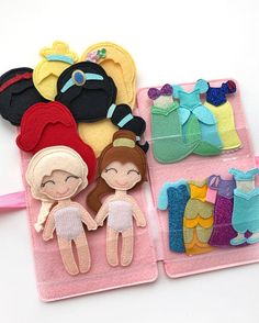 three felt dolls are sitting next to each other