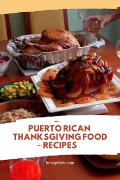 a table topped with turkey and other thanksgiving foods