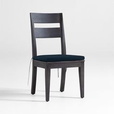 a wooden chair with a blue cushion on the seat and back rest, in front of a white background