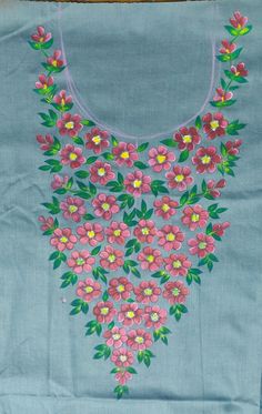 a blue shirt with pink and yellow flowers on the front, hanging from a wooden hanger