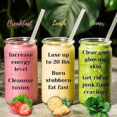 three different smoothies with strawberries and lemons on the side, one is green