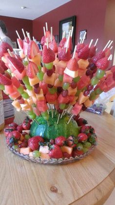 a platter filled with fruit on top of a wooden table