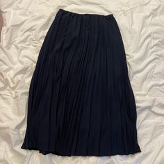 Beautiful And Classic Midi Skirt In Navy Blue. New Without Tags - Never Worn. Uniqlo Lined Skirt For Spring, Elegant Uniqlo Bottoms For Spring, Uniqlo Casual Spring Skirt, Uniqlo Casual Skirt For Spring, Casual Uniqlo Skirt For Spring, Spring Navy Pleated Skirt, Spring Pleated Navy Skirt, Navy Pleated Flowy Skirt, Casual Blue Pleated Midi Skirt