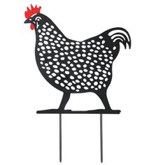 a black and white chicken on top of a metal stand with polka dot dots in the shape of a rooster